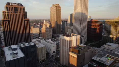 Aerial-tracking-shot-of-the-city-center-of-New-Orleans,-sunny-evening-in-Louisiana,-USA