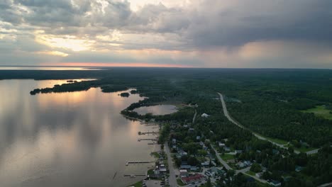 Aerial-sunset-view-of-hessel-michigan-coastline-and-dramatic-clouds,-Les-Cheneaux-Islands,-Michigan