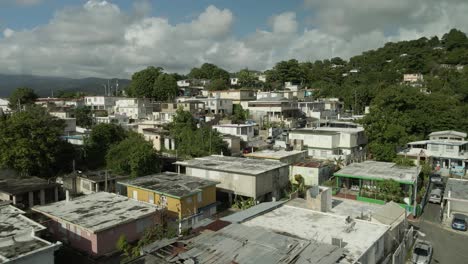 aerial-drone-shot-flying-over-a-mountain-side-hill-puerto-rico-neighborhood