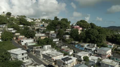 aerial-drone-shot-of-Fajardo-Puerto-Rico-neighborhood-mid-day-ocean-reveal