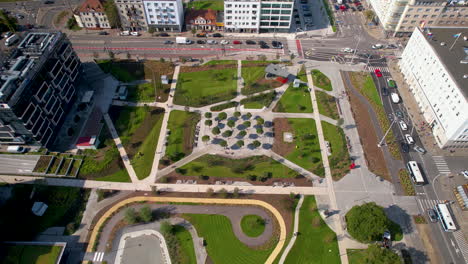 Aerial-over-Park-Centralny-in-Gdynia,-Poland,-revealing-a-stunning-city-park-surrounded-by-traffic