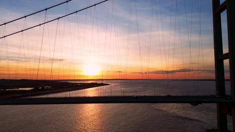 A-captivating-journey-unfolds-as-Humber-Bridge-stands-resplendent-in-the-twilight,-with-cars-moving-in-graceful-motion-below
