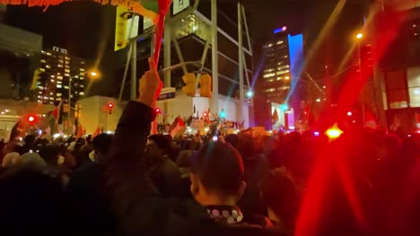 Protestor-waving-Palestinian-flag,-protest-in-Toronto