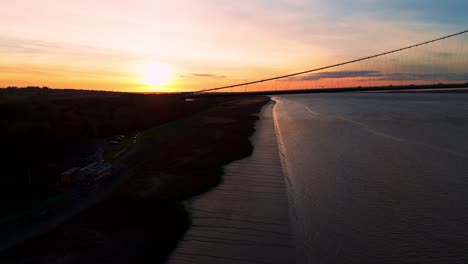 Sunset-silhouette:-Humber-Bridge-and-the-fluid-dance-of-cars-beneath-in-this-aerial-view
