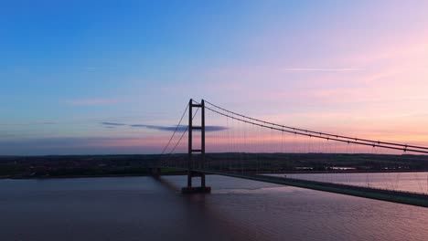 Sunset's-silhouette:-Humber-Bridge-takes-center-stage-as-cars-paint-a-tranquil-picture-in-an-aerial-drone's-view