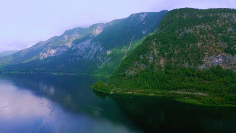 Captivating-Hallstatt's-serene-charm,-our-4K-DJI-drone-footage-showcases-lush-green-mountains,-Hallstätter-See,-and-tranquil-alpine-beauty