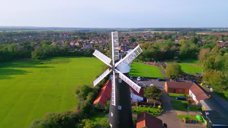 From-above,-video-footage-captures-the-iconic-Waltham-Windmill-and-Rural-History-Museum-in-Lincolnshire,-UK