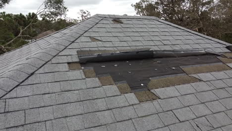 House-roof-damage-from-strong-hurricane-storm-winds-and-rain-water-for-insurance-claim