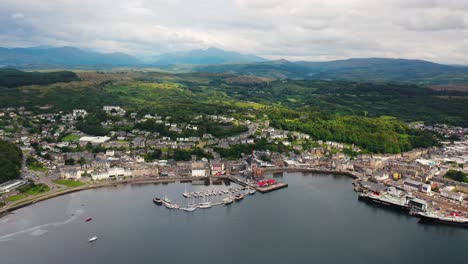 Aerial-View-Over-Oban-Bay-In-Scotland-With-Boats-In-The-Harbour