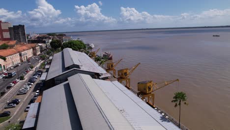 This-drone-video-showcases-the-revitalization-of-the-old-harbor-of-Belém,-situated-the-Guajará-Bay,-now-a-thriving-gastronomical-and-cultural-hub