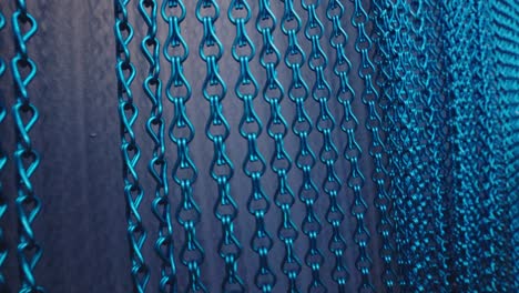 hand-passes-over-blue-metallic--rings-curtain-background