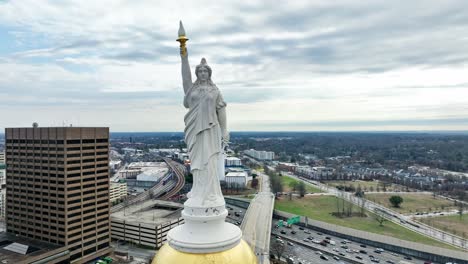 Aerial-orbiting-shot-showing-statue-on-top-Georgia-State-Capitol-in-Atlanta-City