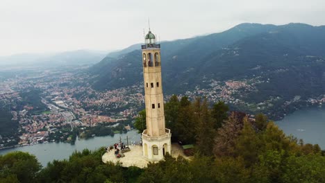 Drone-shot-orbiting-historic-Volta-Lighthouse-with-Lake-Como-in-Italy
