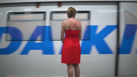 Pretty-Woman-In-A-Red-Dress-Waiting-To-Ride-The-BTS-Sky-Train-In-Bangkok-Thailand