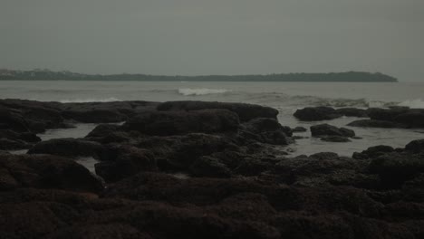 Cinematic-shot-of-a-volcanic-tropical-beach-on-the-Indian-coastline-during-the-rainy-season