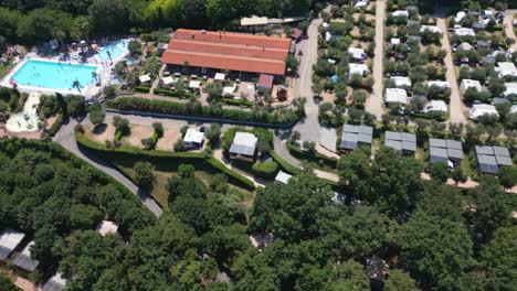 Aerial-Shot-of-Swimming-Pool-at-Weekend-Glamping-Resort-Near-Lake-Garda,-Italy