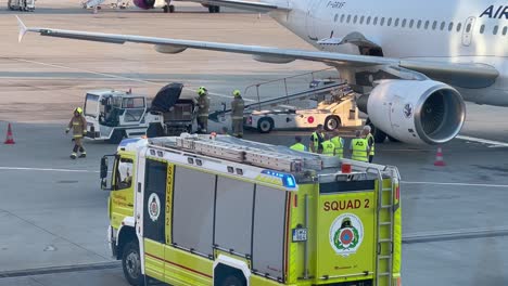 Fire-squad-at-examining-a-luggage-next-to-an-airplane-at-Budapest-Airport,-July-16,-2023
