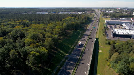 Aerial-Rising-Over-Polish-Expressway-With-Busy-Car-Traffic-Both-Sides,-Gdynia,-Wielki-Kack-Poland