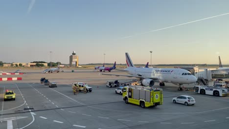 Fire-squad-at-examining-a-luggage-next-to-an-airplane-on-the-runway-of-Budapest-Airport,-July-16,-2023