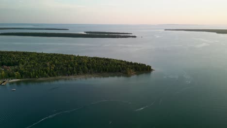 Aerial-descent-of-Marquette-Island-peninsula,-Lake-Huron,-Les-Cheneaux-Islands,-Michigan