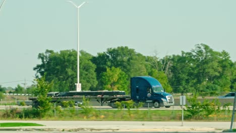 epic-slow-motion-of-a-flatbed-semi-tractor-and-trailer-driving-on-interstate