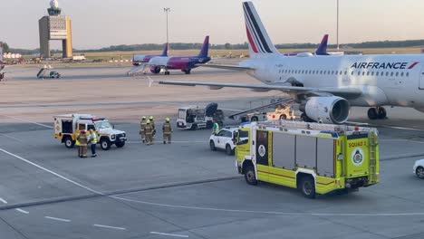 Fire-squad-arriving-to-examine-a-luggage-next-to-an-airplane-at-Budapest-Airport,-July-16,-2023