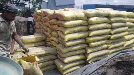 A-heap-of-cement-bags-lying-on-the-ground-at-a-building-construction-site