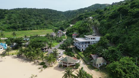 Aerial-dolly-of-panoramic-Puraran-surf-beach-resort-with-lush-palm-trees-in-Baras,-Catanduanes