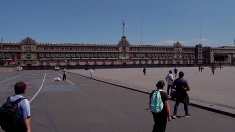 Static-shot-of-tourists-walking-around-the-grounds-infront-of-the-National-Palace
