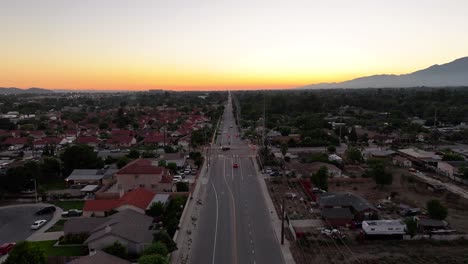 Bloomington-California-aerial-fly-down-busy-street-at-sunset-AERIAL-DOLLY