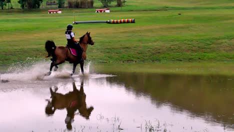 Beautiful-shot-of-a-stallion-and-rider-in-galloping-in-the-water