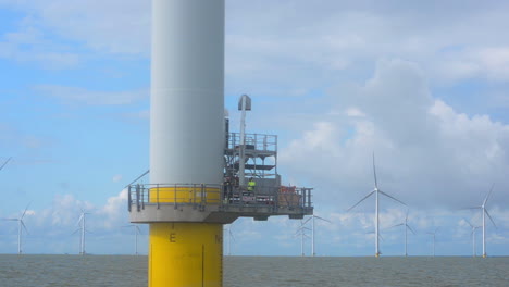 Turbine-maintenance-crew-at-an-off-shore-wind-park,-CLOSE-UP-from-a-nearby-vessel