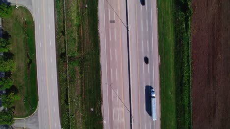 top-down-aerial-of-semi-truck-dry-van-driving-on-interstate-in-america
