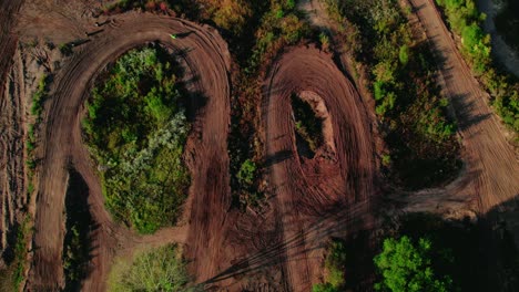 top-down-aerial-motocross-bikes-off-roading-in-forest-tracks