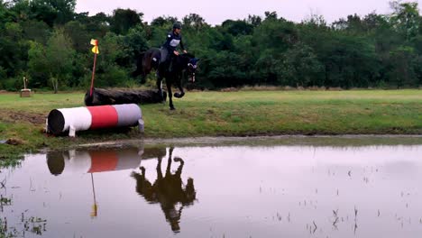 Horse-and-rider-jump-over-an-obstacle-during-a-cross-country-race