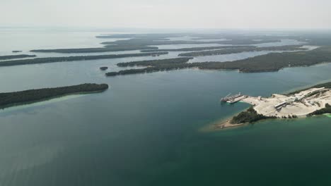 Aerial-pan-of-limestone-quarry-and-les-cheneaux-islands,-Michigan