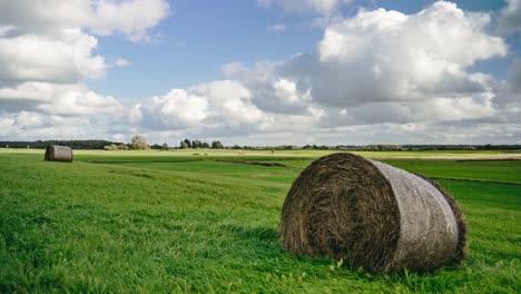 Day-Timelapse-with-Hay-Roll-in-a-field
