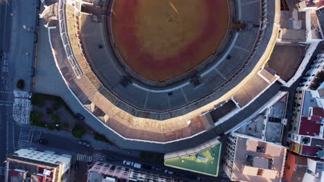 Top-down-aerial-dolly-over-round-Plaza-de-Toros-bullfighting-ring-in-Seville