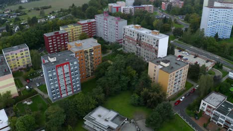 Aerial-drone-shot-of-flat-apartment-complex-in-the-middle-of-city-during-cloudy-day