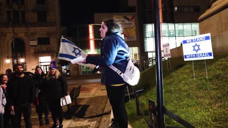 An-animated-woman-speaks-to-a-crowd-of-people-supporting-Israel-in-Portland-Maine