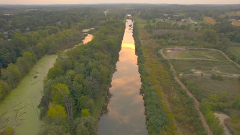 Erie-Canal-drone-shot-at-sunset-you-can-see-reflectionnear-Downtown-Palmyra-in-New-York-State-USA