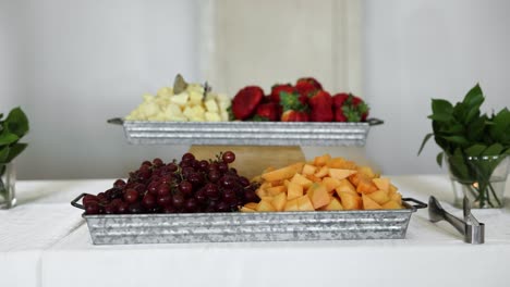 Fruit-Platter-with-Grapes,-Cantaloupe,-Strawberries,-and-Pineapple-on-Table