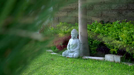 Tranquil-scene-featuring-a-stone-Buddha-statue-in-a-serene-garden-setting,-radiating-a-sense-of-peace-and-spirituality