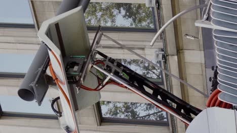 Vertical-video-of-pantograph-for-electric-bus-charging-at-the-bus-station---close-up