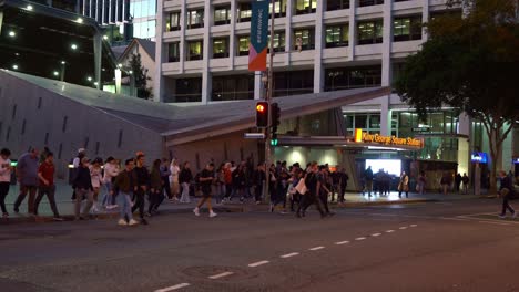 Static-shot-of-massive-crowds-at-bustling-downtown-Brisbane-city,-people-crossing-the-road-on-Albert-and-Adelaide-street-in-Brisbane-city-between-King-George-Square-station-and-Queen-street-mall