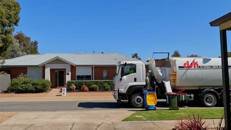 Yarrawonga,-Victoria,-Australia---22-September-2023:-Rubbish-truck-emptying-domestic-rubbish-bins-in-a-suburban-street