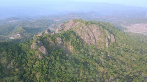 Aerial-view-of-beautiful-landscape-of-towering-rock-mountains-with-dense-of-forest