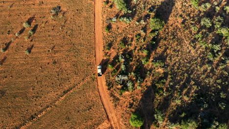 Farming-vehicle-driving-along-a-dry-dusty-terrain-on-a-surveillance-drive-of-his-farmland