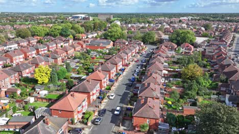 Red-and-orange-roofed-town-homes-line-sub-division-surrounded-by-lush-trees,-Doncaster-England