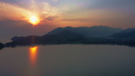 Sun-rising-above-hills-and-village-on-sea-bay-coast-in-Koh-Chang